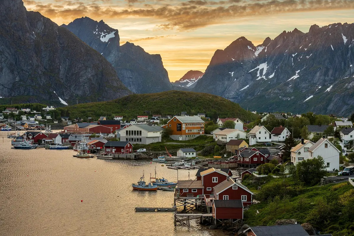 Red fishing houses of Reine below steep peaks